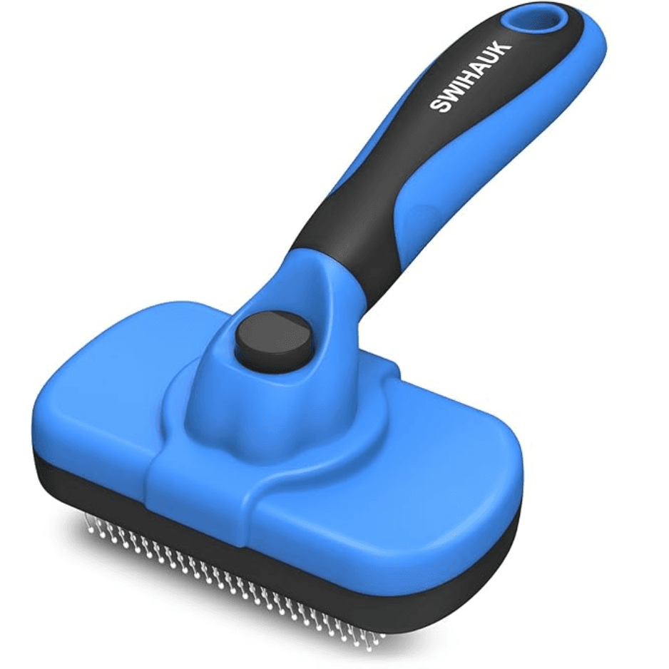 Self Cleaning Slicker Brush next to a fabric sofa