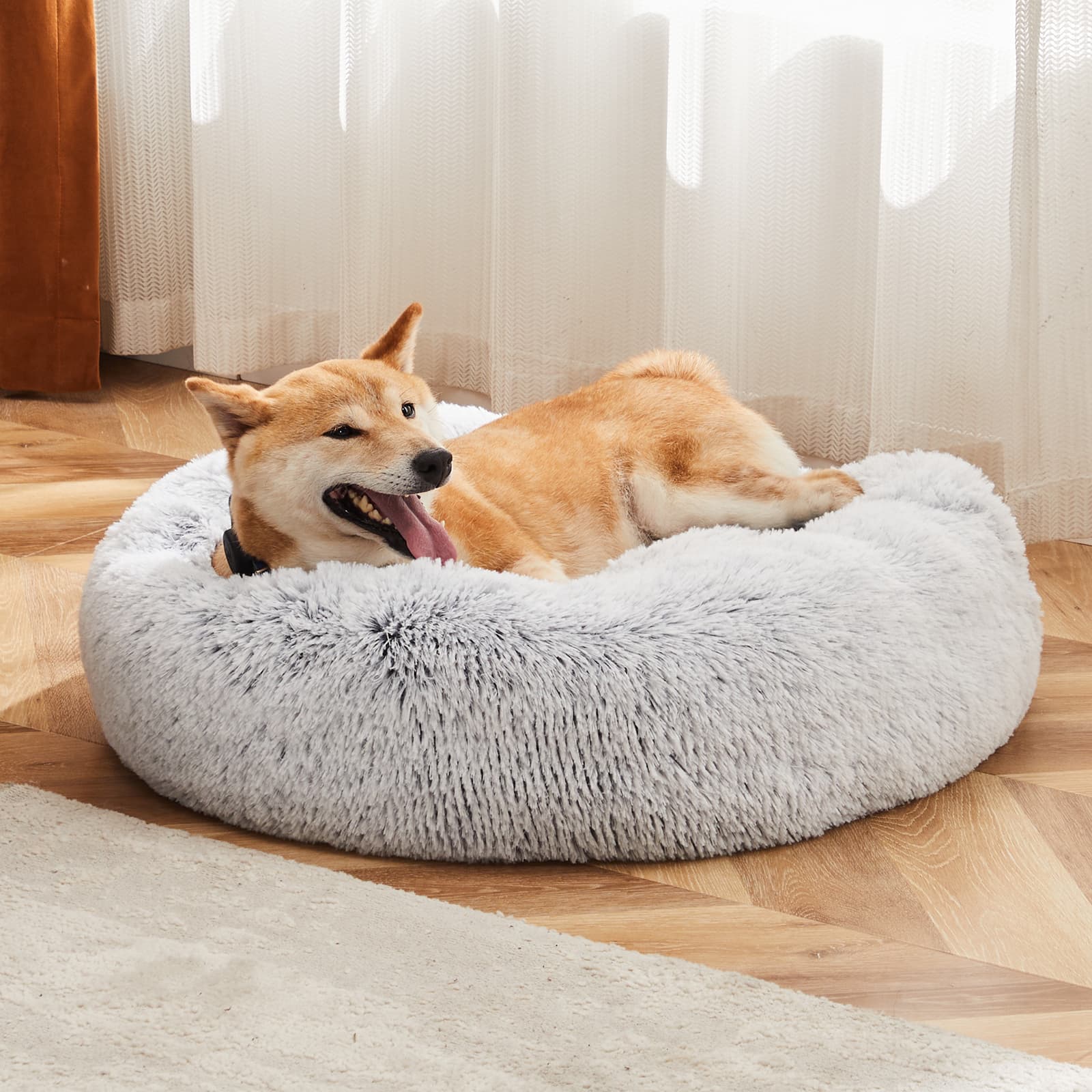 Anti-Slip Round Fluffy Plush Faux Fur Pet Bed in a warmly lit living room